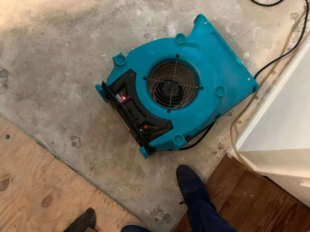 Air mover drying subfloor during Commercial Water Damage Restoration in Swannanoa